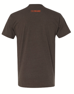 The back of a brown short sleeve fishing t-shirt with an orange logo near the collar. 